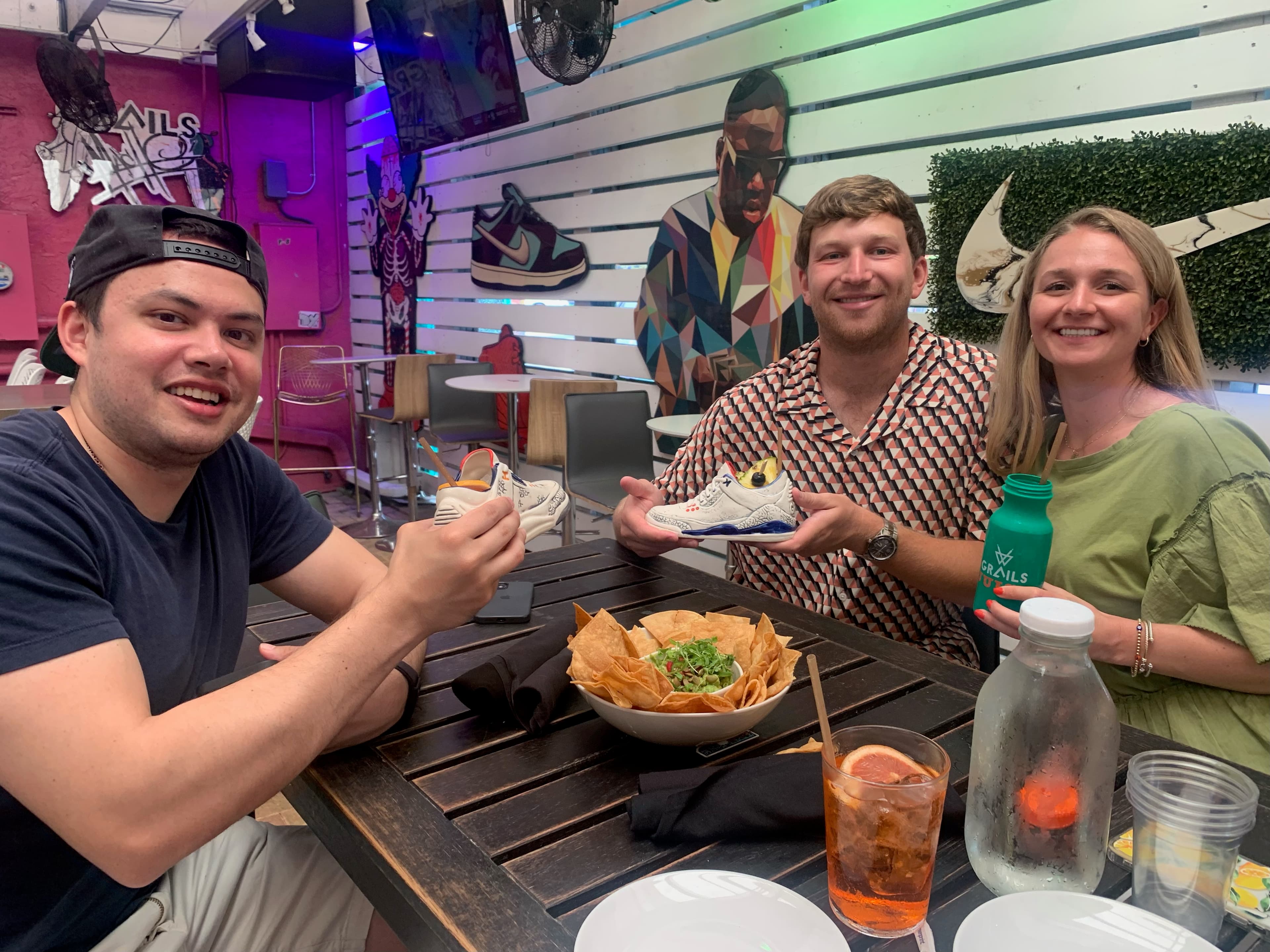 Cole at a sneaker shop showing off shoes